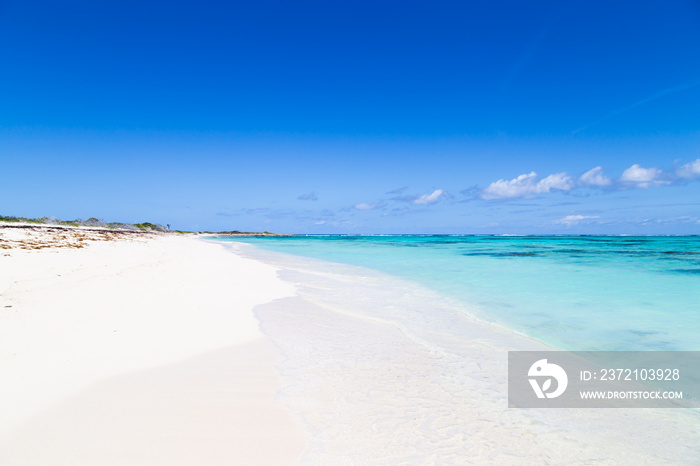 Gorgeous white sand beach and blue sky on Turks and Caicos Islands. 