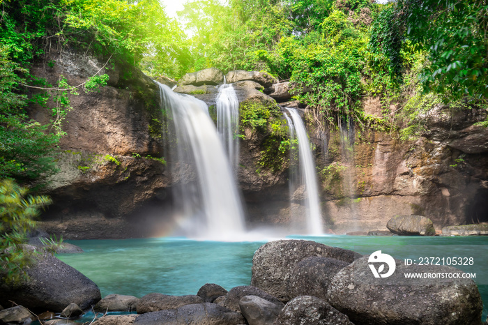 Travel to the beautiful waterfall in deep forest, soft water of the stream in the natural park at Ha