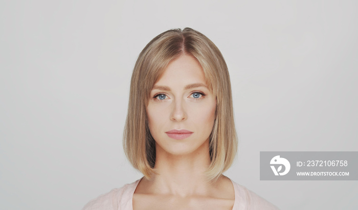 Studio portrait of young, beautiful and natural blond woman.