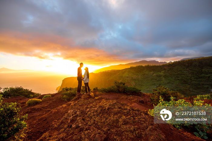 Couple enjoying beautiful sunrise