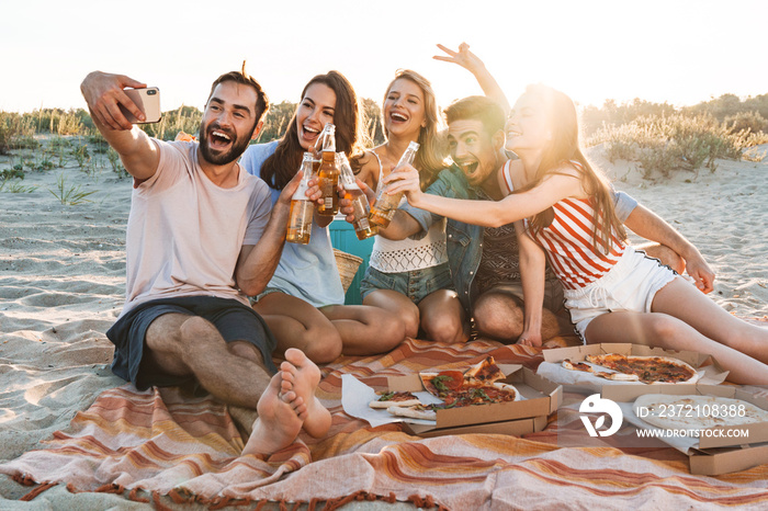 Group of happy friends spending time together at the beach