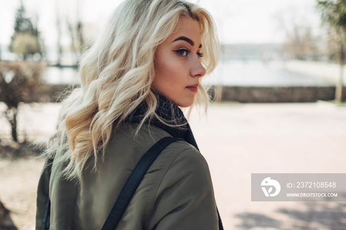 Portrait of Beautiful Blonde Girl in Green Jacket