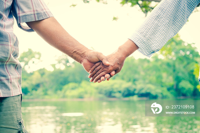 Asian elderly couple holding hands together, love each other and take care of each other forever. Th