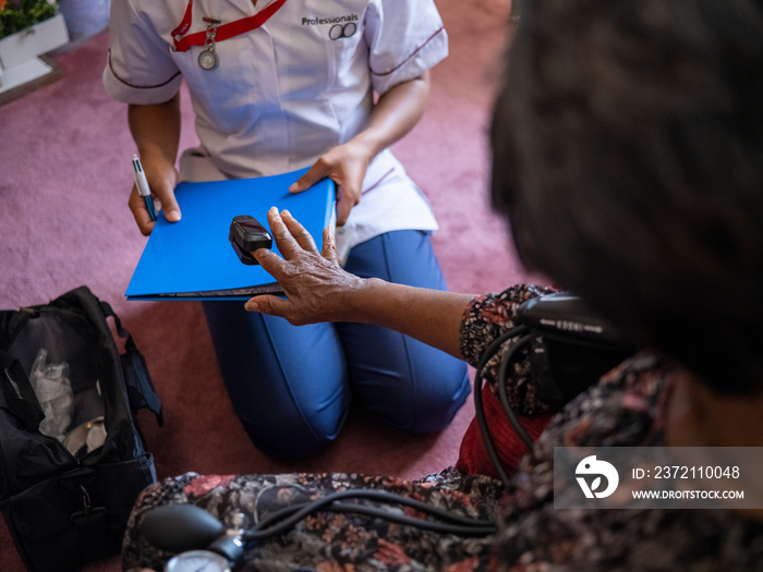 Nurse�taking care of elderly woman, measuring oxygen saturation