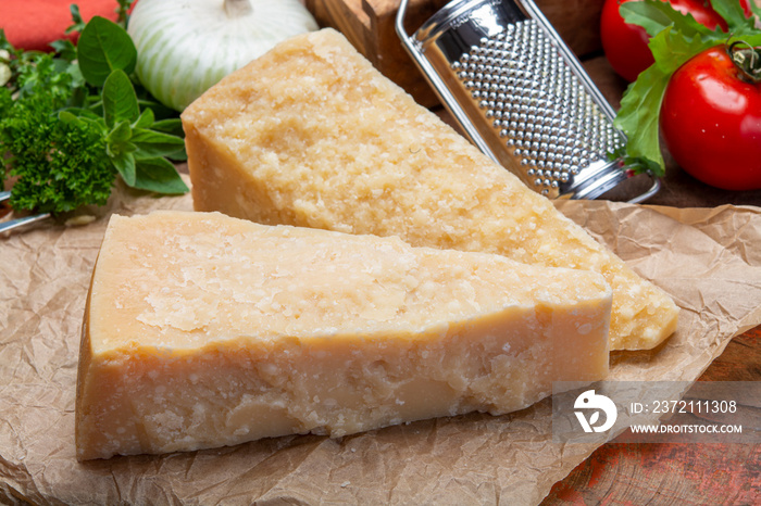 Italian original aged Parmesan cheese in two pieces close up