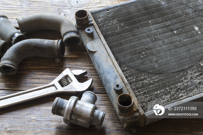 Old car radiator on a wooden table.