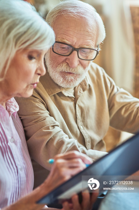 Elderly man and woman checking internal finances