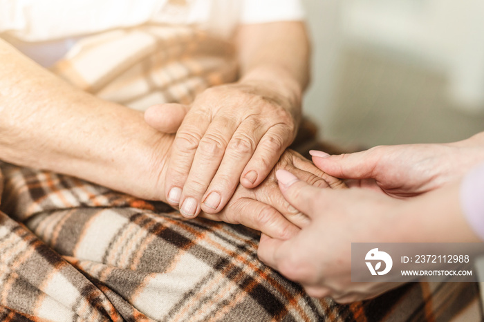 Old and young holding hands, Care for the elderly concept