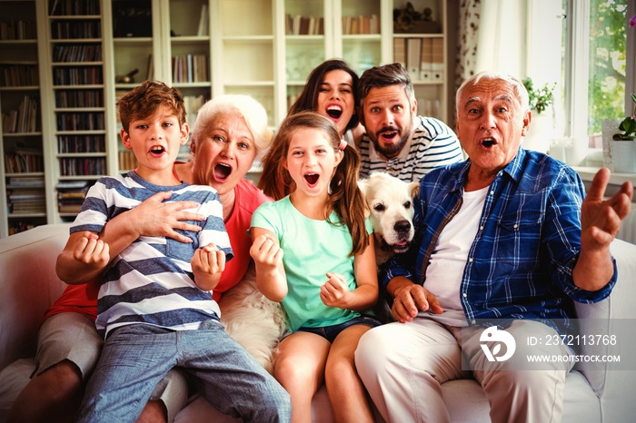 Happy family watching television in living room