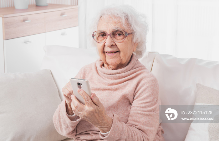 Great-grandmother talking by smartphone