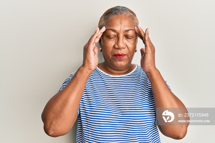 Senior african american woman wearing casual clothes with hand on head, headache because stress. suf