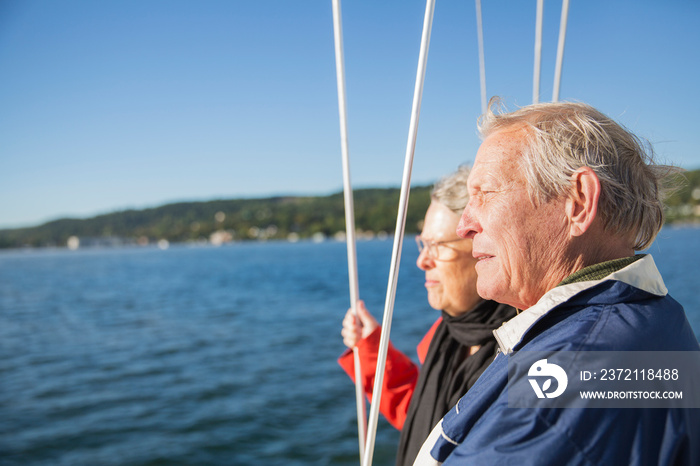 Smiling senior couple on sailboat