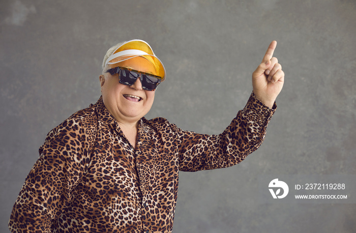 Headshot portrait of funny excited crazy stylish handsome old man wearing sunglasses, shirt with tig