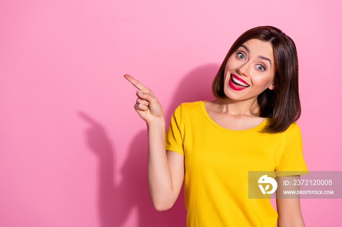 Portrait of attractive amazed girlish cheerful girl showing copy space solution isolated over pink p