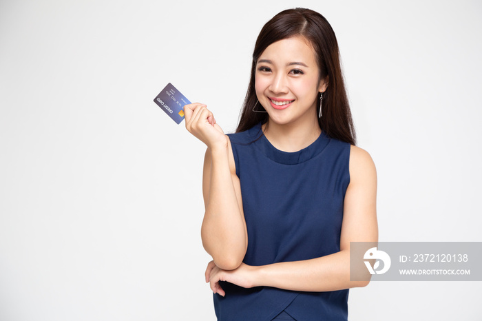 Young Asian lady smiling and holding credit card isolated over white background