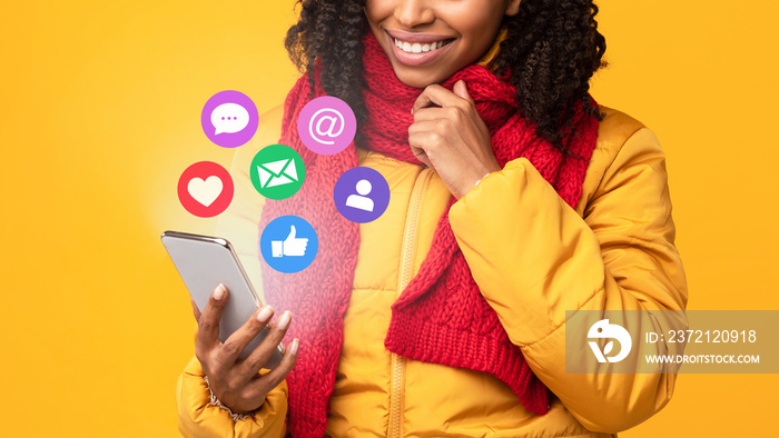 African Woman With Smartphone Using Social Media Over Yellow Background