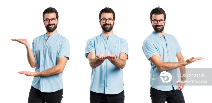 Handsome man with blue glasses presenting something