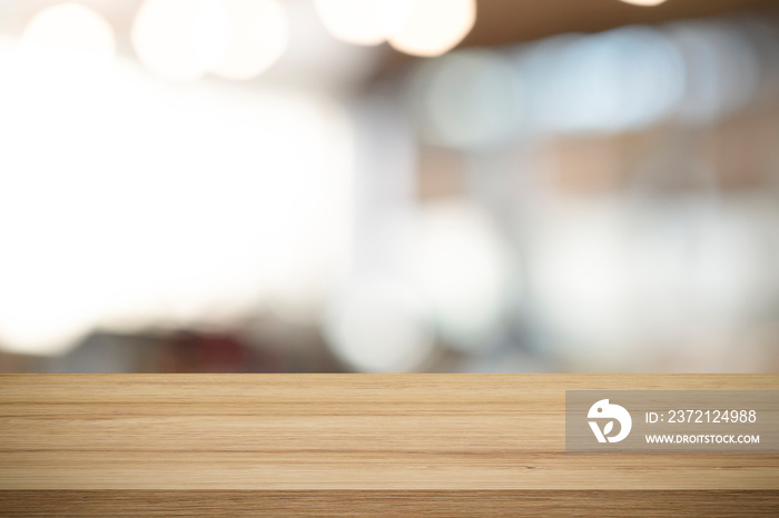 Empty wooden table for present product on coffee shop blur background.