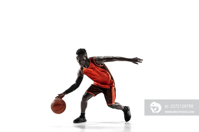 Full length portrait of a basketball player with a ball isolated on white studio background. adverti