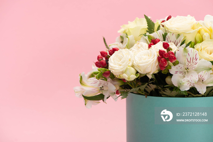 bouquet of flowers in turquoise gift box isolated on pink