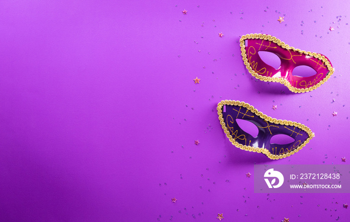 Happy Purim carnival decoration concept made from mask and sparkle star on purple background. (Happy