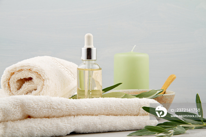 Spa and wellness composition with serum, towels and beauty products