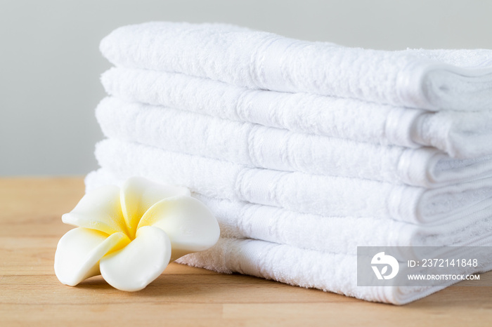 Plumeria flower with stack of white towel
