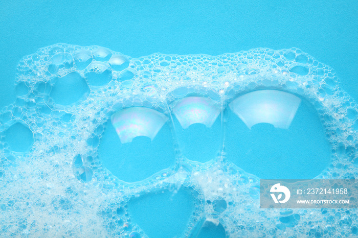 Background soap suds (foam) and bubbles from detergent. House cleaning concept.