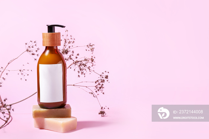 Bottle of natural shampoo on color background