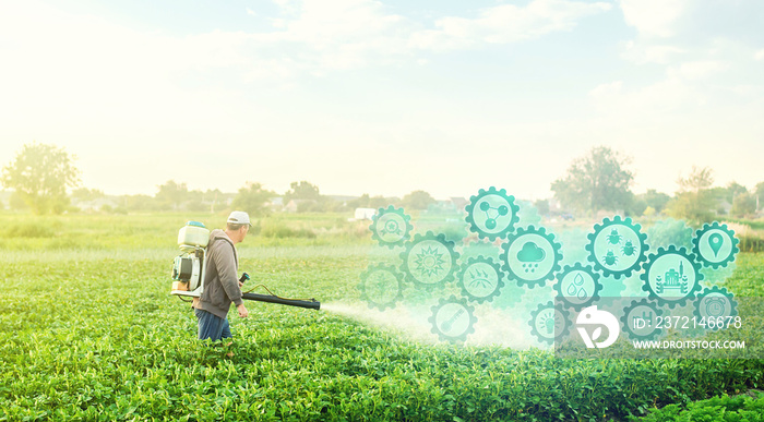 A farmer with a mist blower on potato plantation and technological innovation gears hologram. Using 