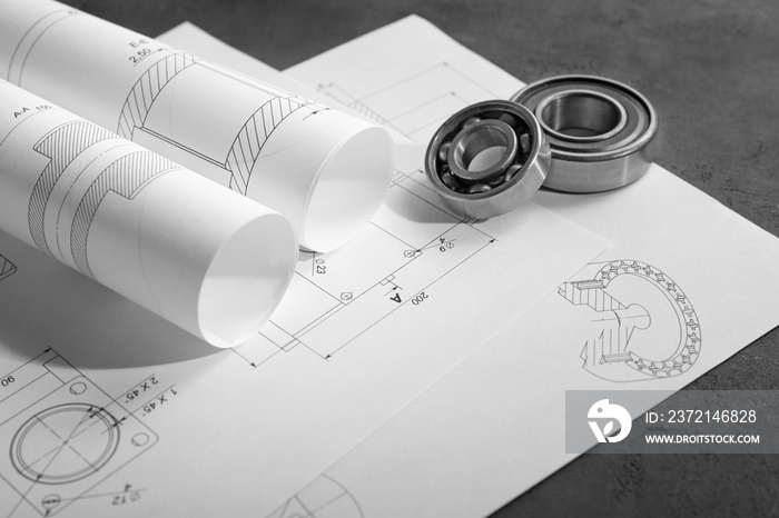 Engineering supplies and part blueprints on workplace