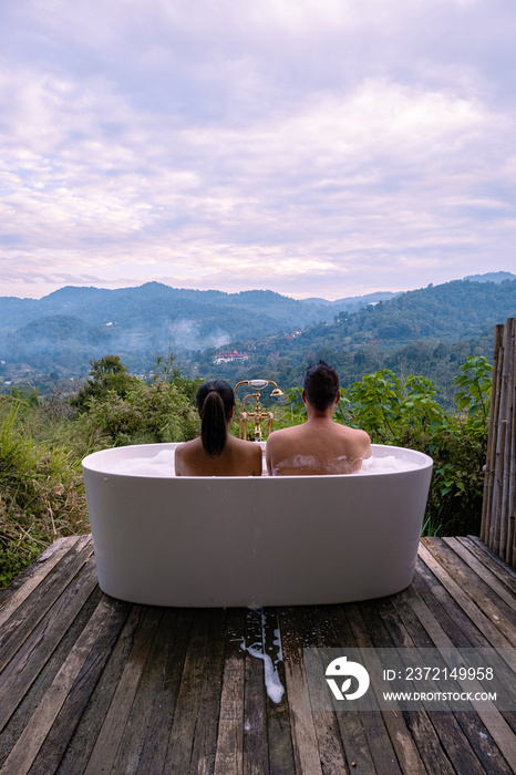 Bathtub during sunset in the mountains of Chiang Mai Thailand, relaxing in outdoor wood fire hot tub