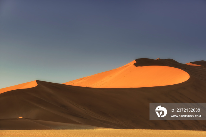 Sossusvlei salt pan with high red sand dunes in Namib desert, Namibia, Africa.