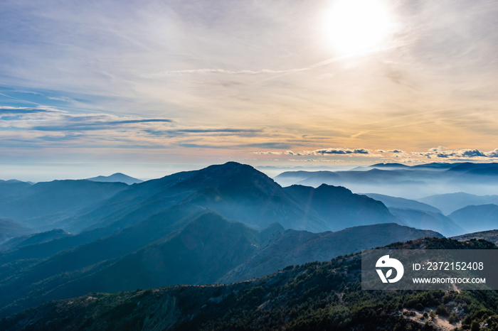 Beautiful captivating landscape of the layered misty hazy French Alps mountain range in Alpes-Mariti