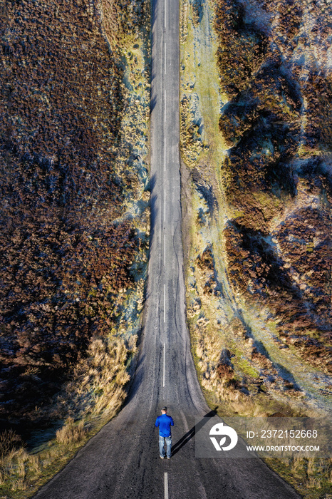 Man stood on a road with a drone bending inception effect