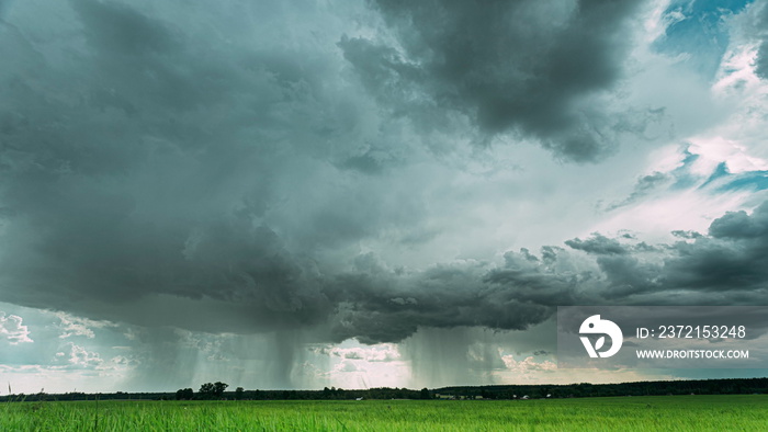 4K Rain Rainy Clouds Above Countryside Rural Field Landscape With Young Green Wheat Sprouts In Sprin