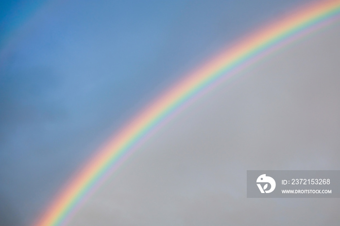 Rainbow in the blue sky background