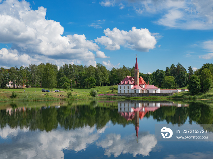 Sunny landscape with old castle on the pond. Russia. Gatchina city