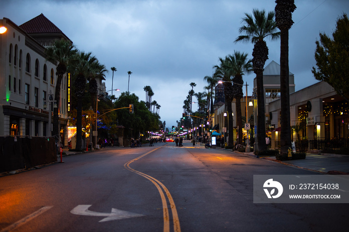 Downtown California street with palm trees at evening