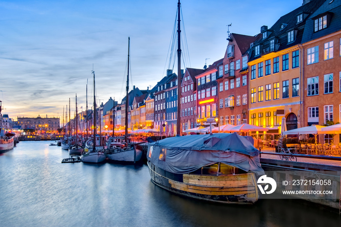 Nyhavn with its picturesque harbor with old sailing ships and colorful facades of old houses in Cope