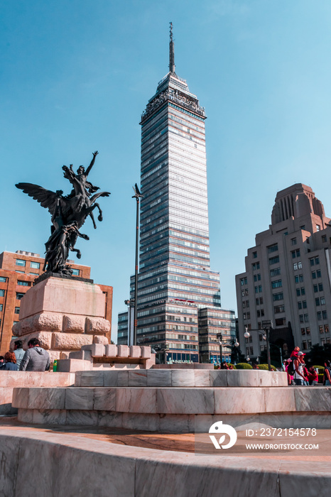 Fullshot view of a famous skyscraper called  Torre Latinoamericana  and a sculpture located in Refor