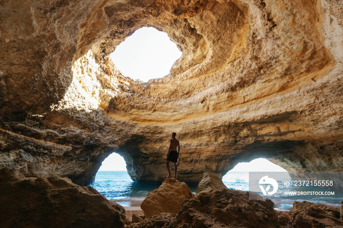Man standing in the Benagil caves in Portugal