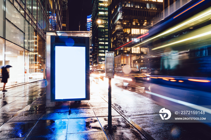 Bus station billboard in rainy night with blank copy space screen for advertising or promotional con