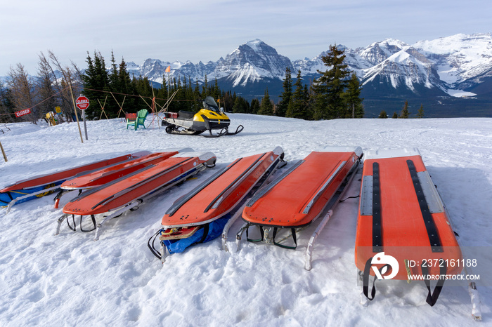 Ski Patrol Rescue Toboggans on Snow in Mountain Ski Resort