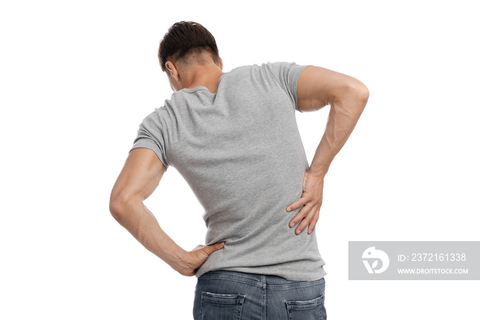 Millennial european man suffer from muscle pain, pressing hand to back