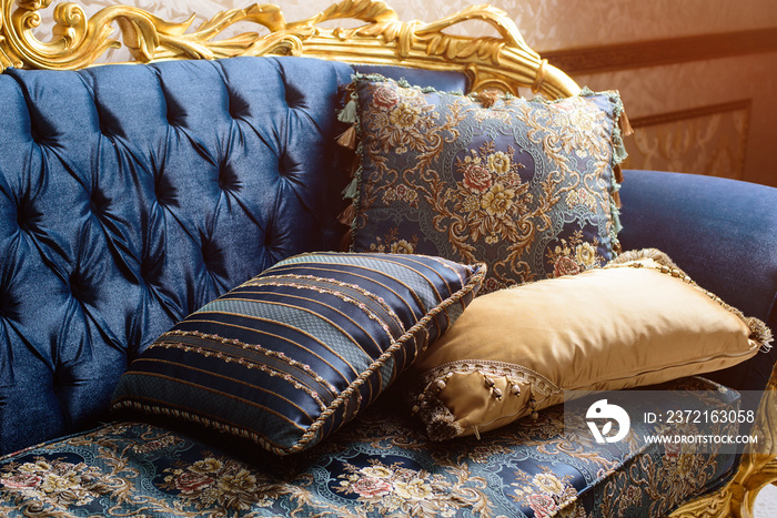 Luxury blue sofa with pillows. Baroque style.