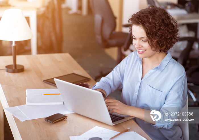 Pleasant  woman using laptop