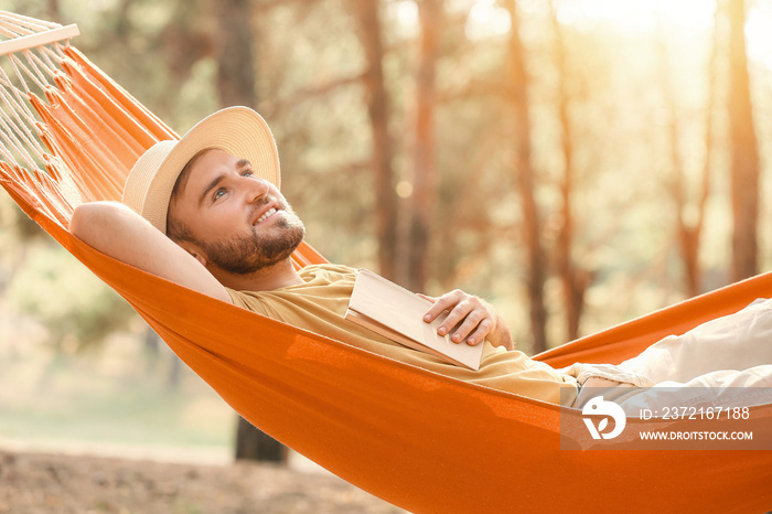 Young man relaxing in hammock outdoors