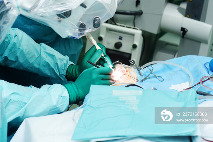 neurosurgeons perform surgery to excise a brain tumor in a modern surgical operating room