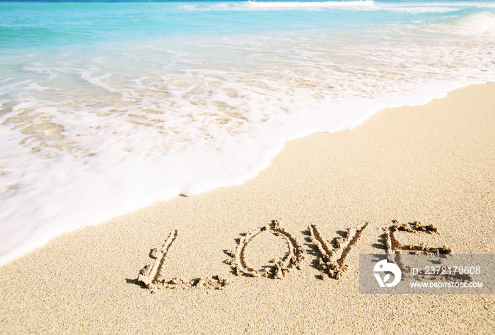 Love inscribed in the sand of a beach